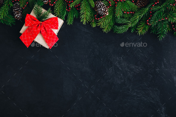 Christmas festive background with christmas tree branches, fir cones and gift box - Stock Photo - Images