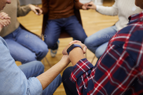 People Holding Hands in Support Group
