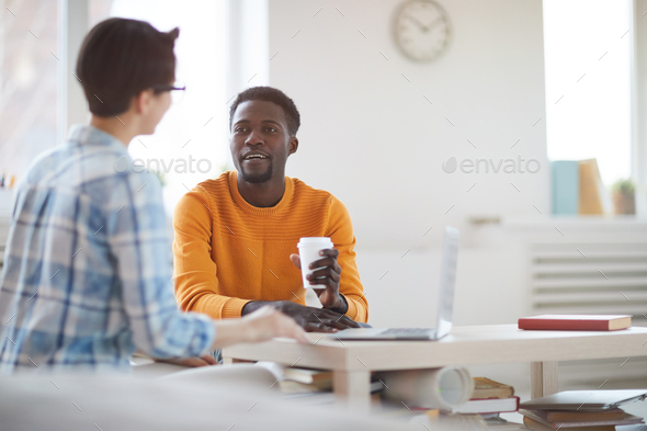 Modern African Man Talking to Colleague in Office