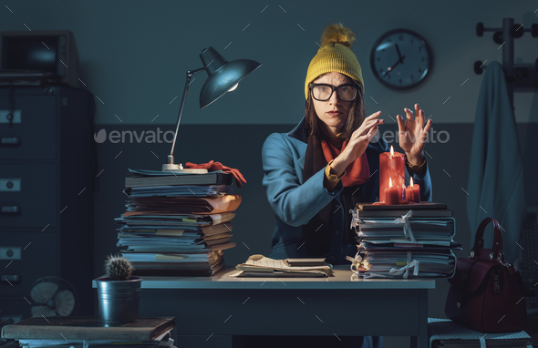 Disappointed businesswoman freezing in the office - Stock Photo - Images
