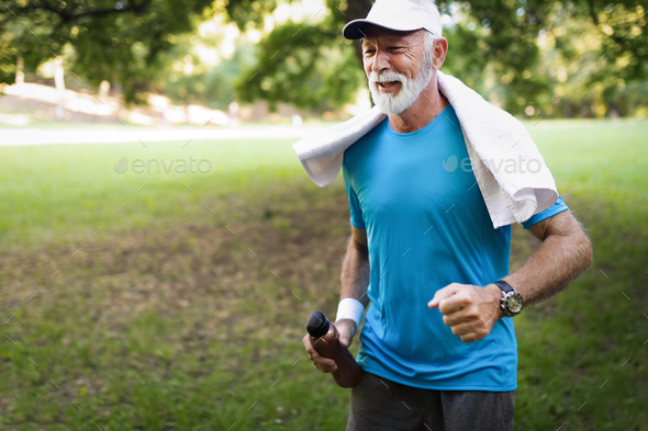 Portrait of athletic mature man after run. Handsome senior man resting after jog at the park