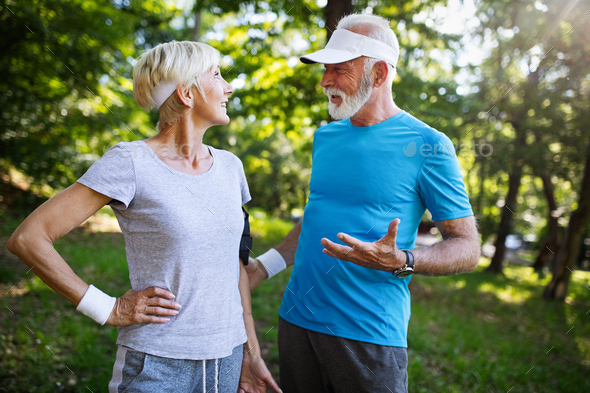 Senior couple jogging and running outdoors in nature
