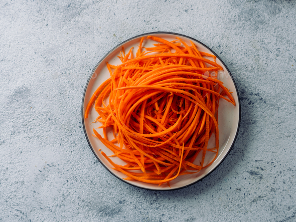 Raw carrot noodles or spaghetti, top view - Stock Photo - Images