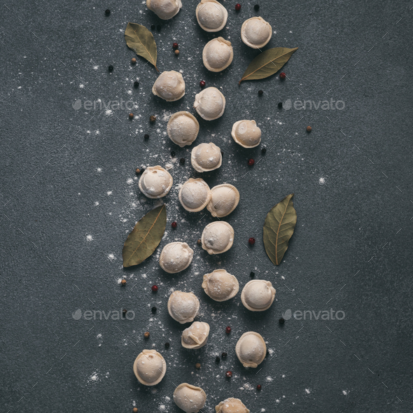 Beautiful scattered raw pelmeni on marble background - Stock Photo - Images