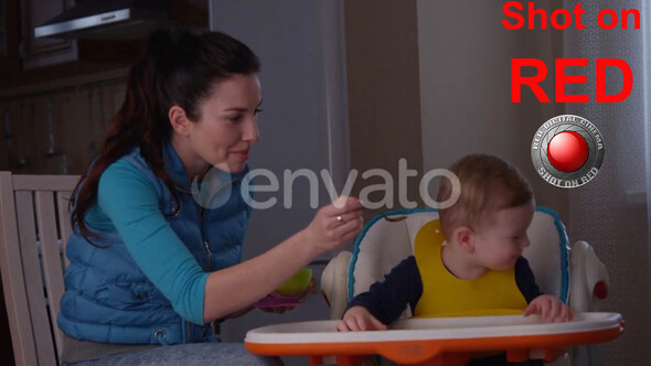 Mother Trying To Feed Her Child And He Does Not Want To Eat Porridge And Crying alt