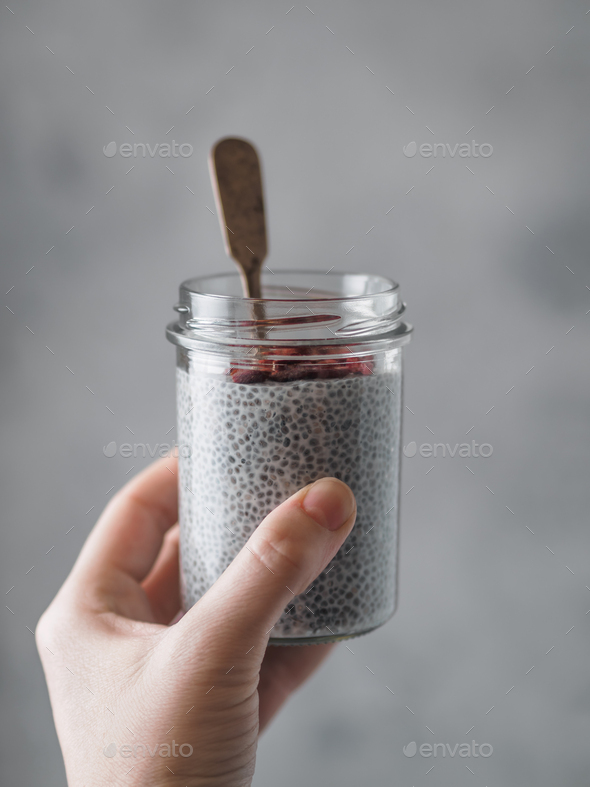Chia pudding in woman hand - Stock Photo - Images