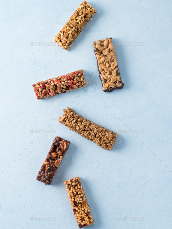 Set of different granola bars on blue background - Stock Photo - Images