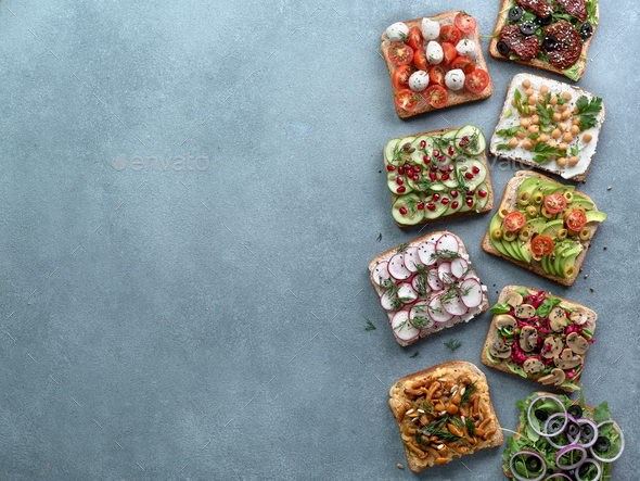 Assortment vegan sandwiches on gray stone background - Stock Photo - Images