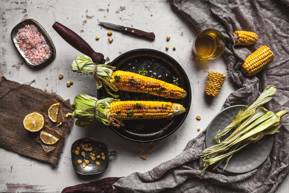 Grilled corn cobs with sauce, coriande on old shabby wooden white background. Mexican food. Top view - Stock Photo - Images