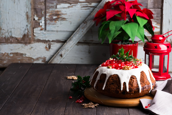 Christmas chocolate cake with white icing and pomegranate kernels on a wooden dark background with - Stock Photo - Images