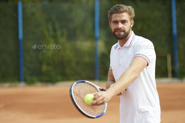 Tennis player with ball and racket