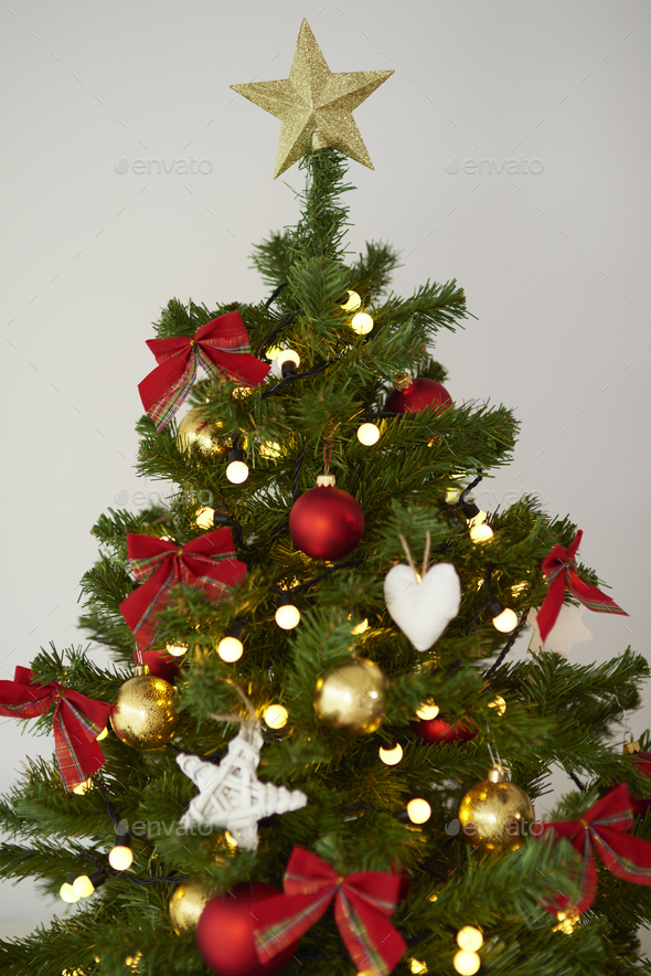 Golden star on the top of the Christmas tree Stock Photo by gpointstudio