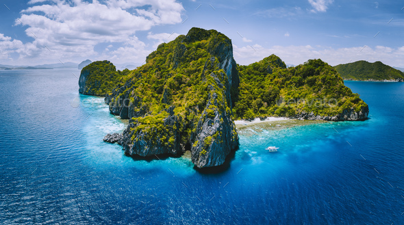 Aerial drone panorama view of tropical paradise island. Karst limestone rocky mountains surrounds by - Stock Photo - Images
