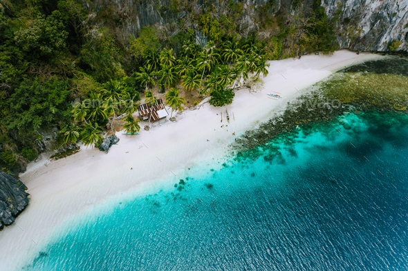 Aerial drone view of abandoned house hut on Pinagbuyutan Island in El Nido. Amazing white sand beach - Stock Photo - Images