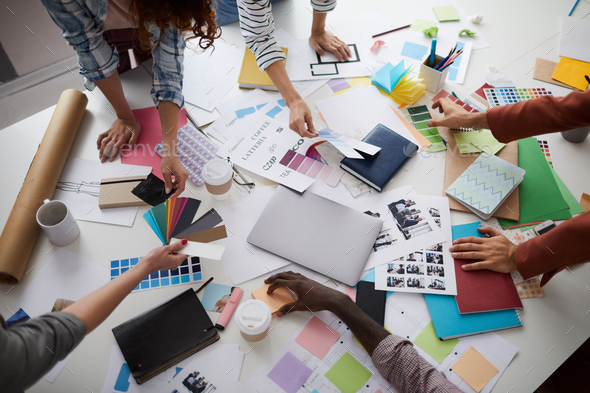 Creative Designers Discussing Production over Table - Stock Photo - Images