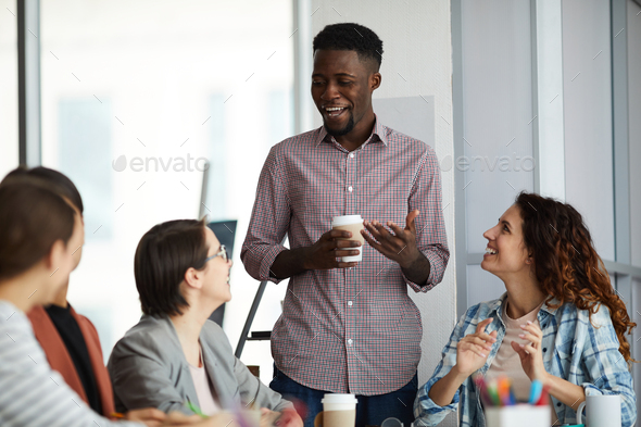 Young African-American Man Giving Speech in Meeting