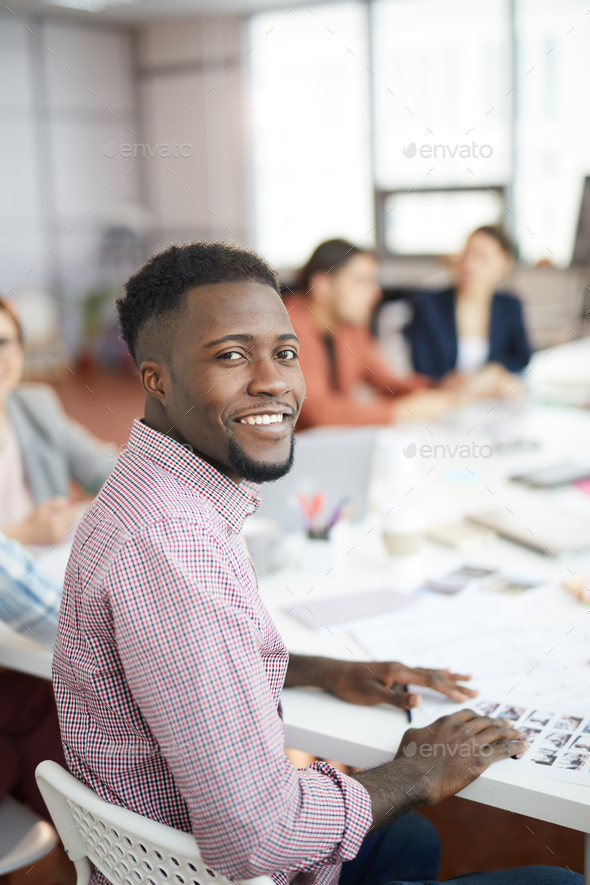Smiling African-American Man Posing in Production Agency