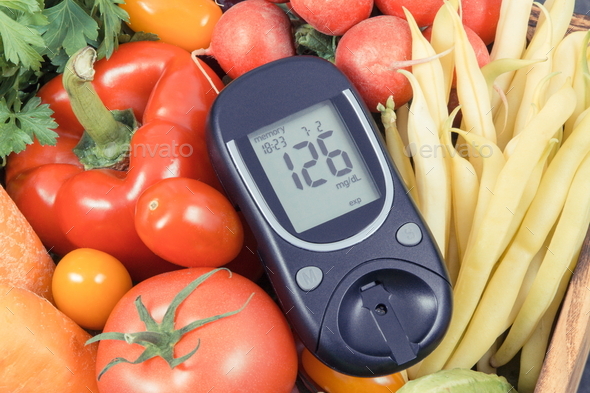 Glucometer with fresh vegetables as source minerals and vitamins - Stock Photo - Images