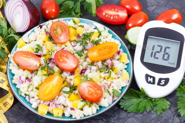Glucometer with sugar level, salad with vegetables and bulgur groats, tape measure - Stock Photo - Images