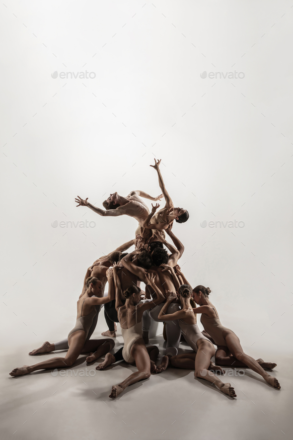 The group of modern ballet dancers. Contemporary art ballet. Young flexible athletic men and women - Stock Photo - Images