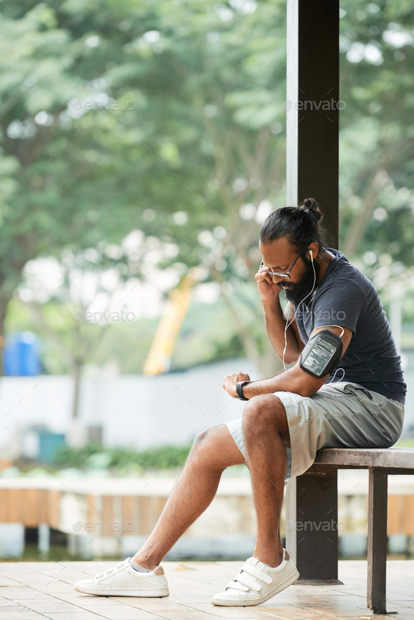Male Runner Taking Pulse - Stock Photo - Images
