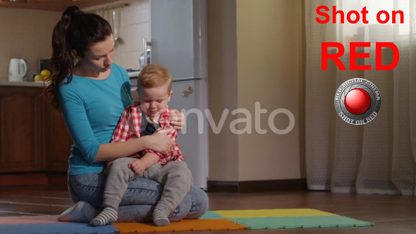 Measuring Temperature Caring Mother Checking With Thermometer Sick Baby Boy In Living Room on RED alt