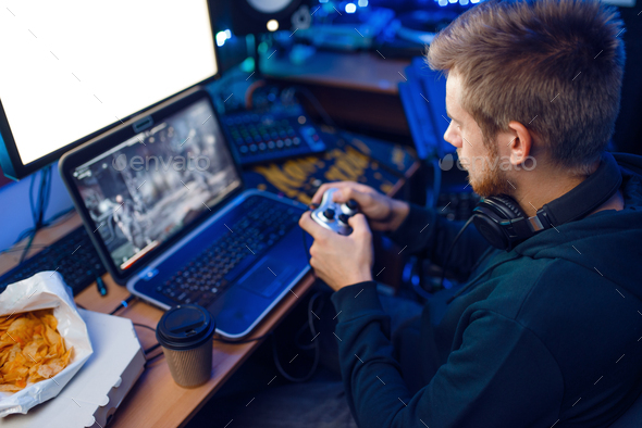 Gamer with joystick playing videogame on console - Stock Photo - Images