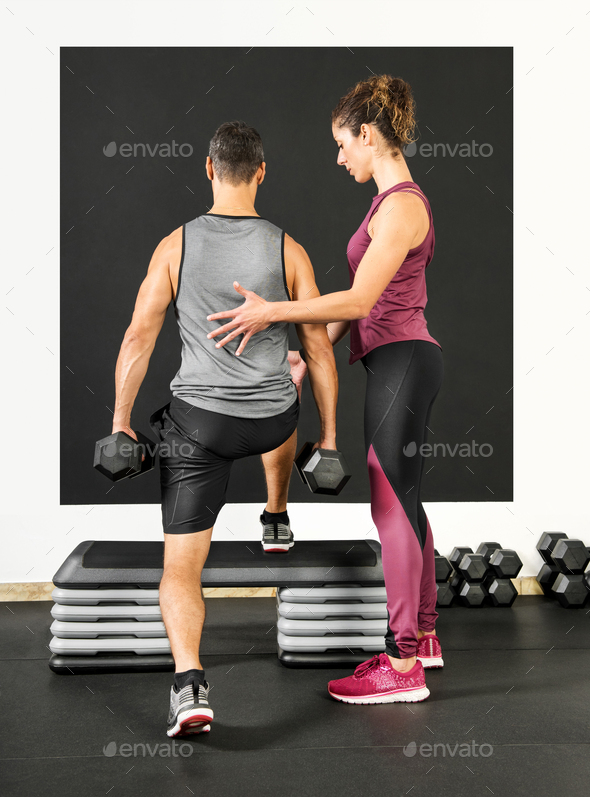 Female personal trainer in a gym Stock Photo by Photology75