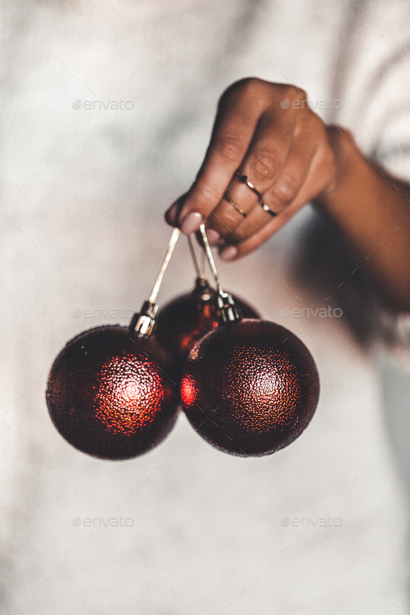 Woman in warm sweater holding toy glass decorative ball in hands, copy space. Christmas, new year - Stock Photo - Images