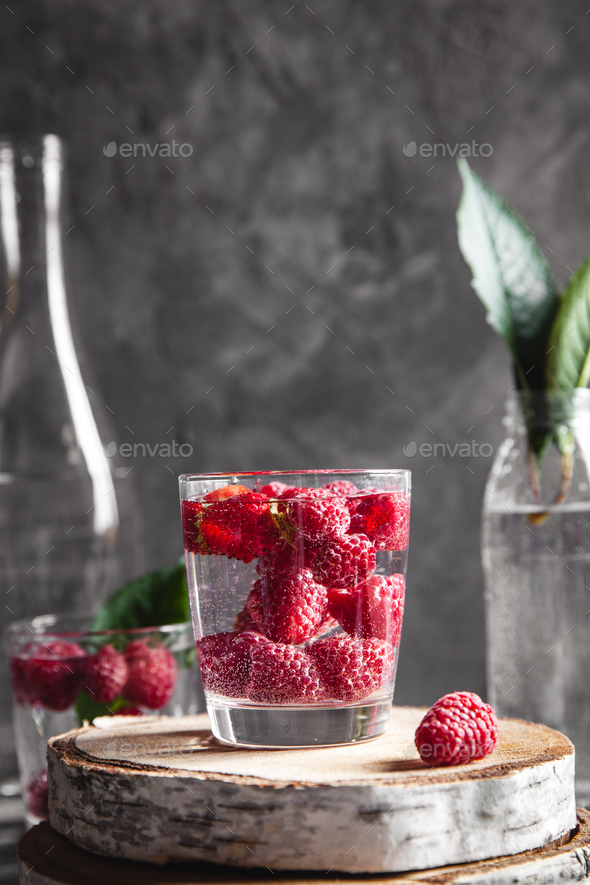 Strawberries in water on a dark gray background. Healthy food, fruit. A bouquet of flowers