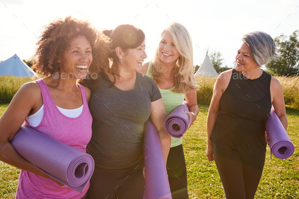 Group Of Mature Female Friends On Outdoor Yoga Retreat Walking Along ...