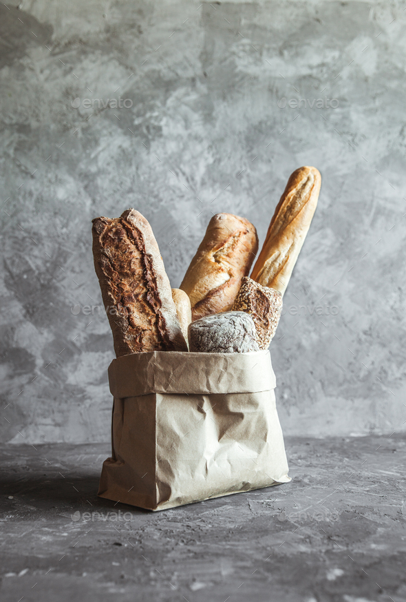 French pastries, baguettes on a gray background in a paper bag