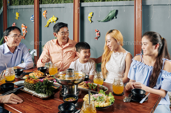 Big Asian family enjoying dinner together