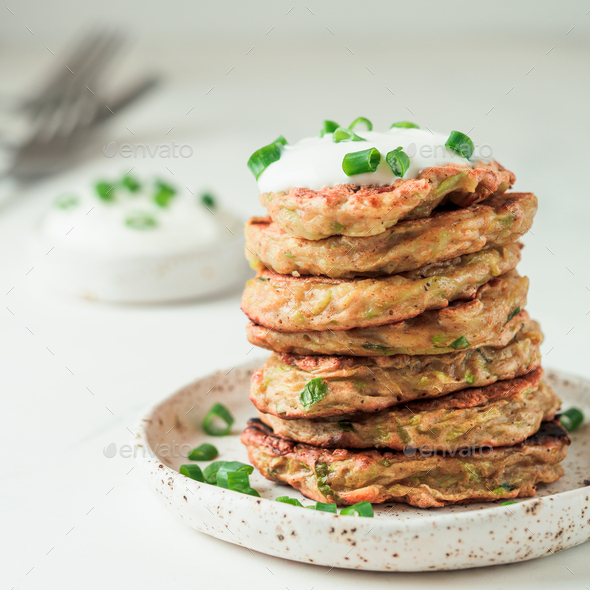 Traditional zucchini fritters, served sour cream - Stock Photo - Images