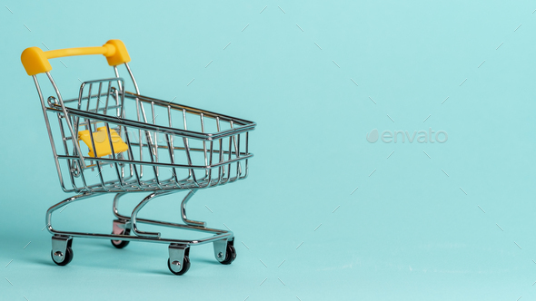Shopping cart staggered on blue, copy space