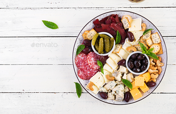 Antipasto platter with basturma, salami, blue cheese, nuts, pickles and olives - Stock Photo - Images