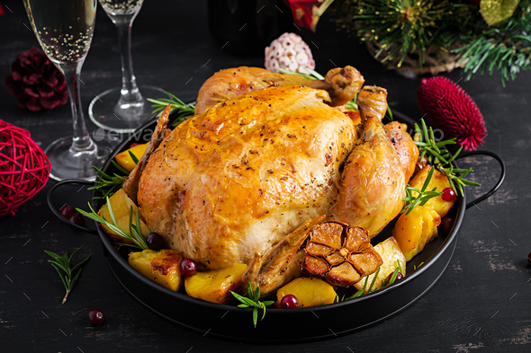 he Christmas table is served with a turkey, decorated with bright tinsel. - Stock Photo - Images