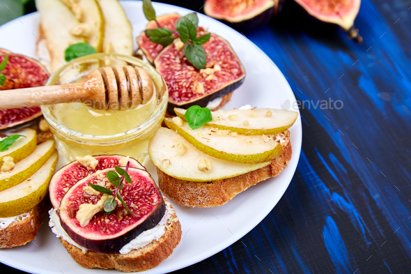 Bruschetta and Crostini with pear, ricotta cheese, honey, figs. - Stock Photo - Images