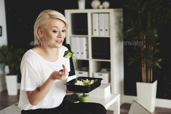 Woman eating salad during lunch hour