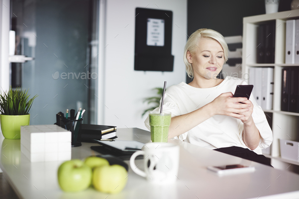Businesswoman using a mobilephone while lunch hour