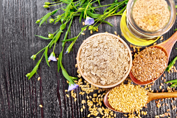 Flour linen in bowl with oil and flowers on board top - Stock Photo - Images