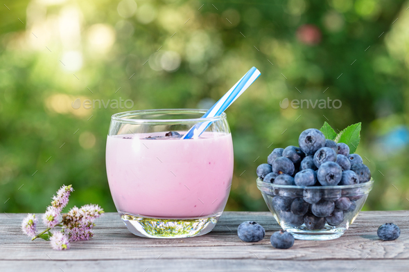 Download Blueberry Smoothie Or Yogurt In Glass Cup With Straw And Berries Stock Photo By Alexlukin