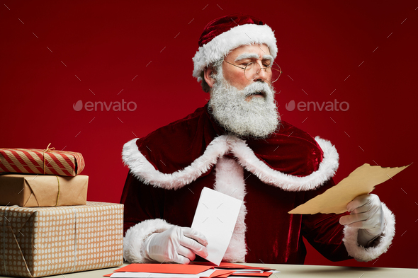 Santa Claus Reading Letters On Red Stock Photo By Seventyfourimages