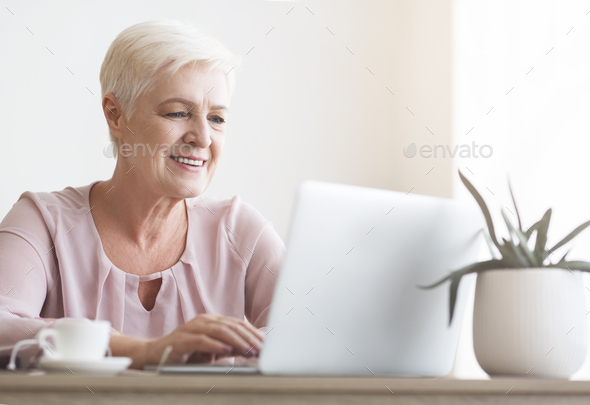 Close up of senior woman working with laptop