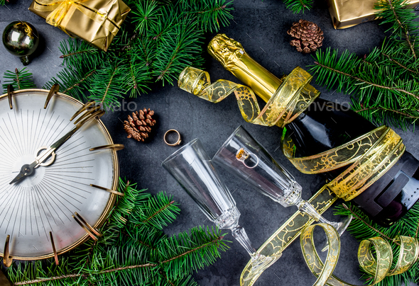 Hispanic New Year Eve tradition rutual put gold ring to champagne. - Stock Photo - Images