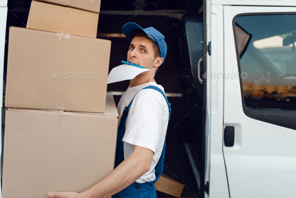Loader holding stack of parcels, delivery service
