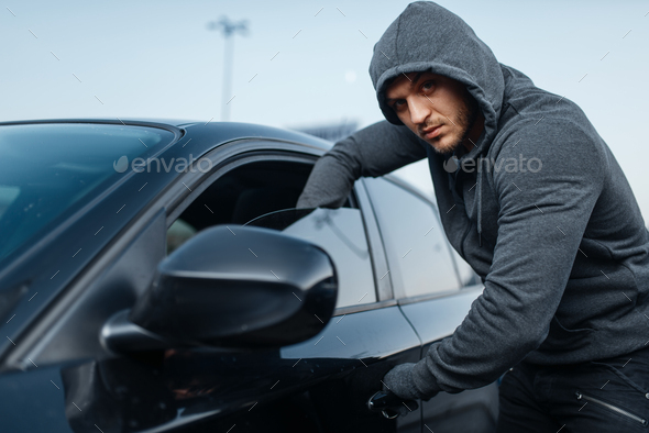 Car thief breaking door, criminal job, burglar