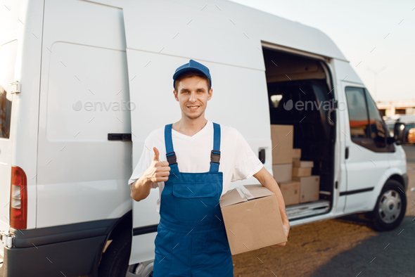 Deliveryman in uniform shows thumbs up, delivery - Stock Photo - Images
