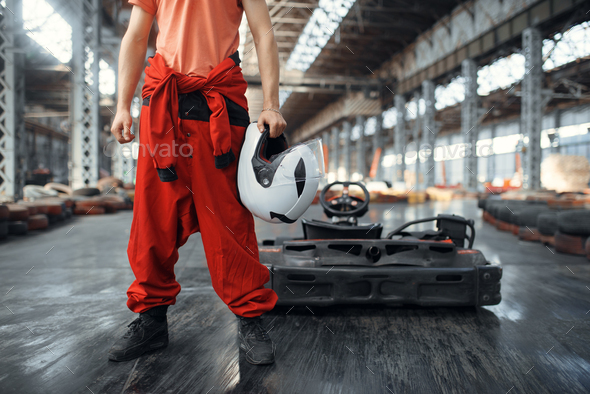 Racer with helmet, go kart car on background - Stock Photo - Images