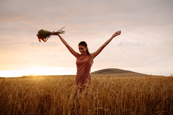 Woman enjoying a day in wheat field - Stock Photo - Images